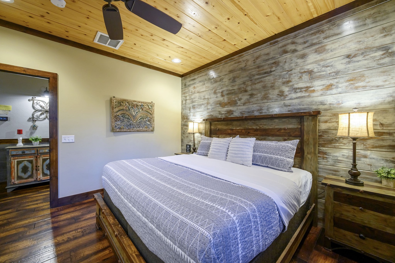 Drift off under the warm glow of rich wood ceilings and rustic plank walls, where thoughtful details and soft linens invite your most restful nights.