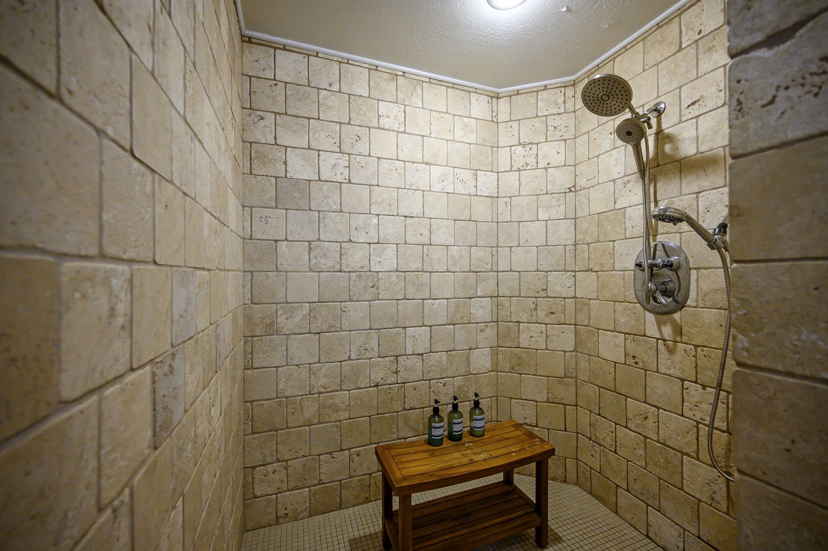 Step into your private sanctuary with elegant stone walls, rainfall shower, and thoughtful amenities for pure relaxation.