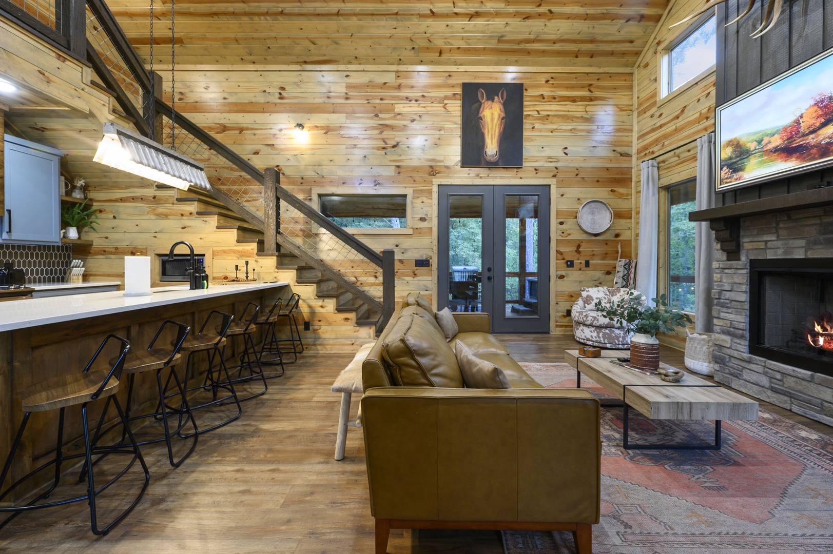 Gather around the kitchen island or sink into the leather sofa beside your crackling stone fireplace. This open-concept cabin blends rustic wood charm with modern comfort, inviting you to relax, cook, and connect.