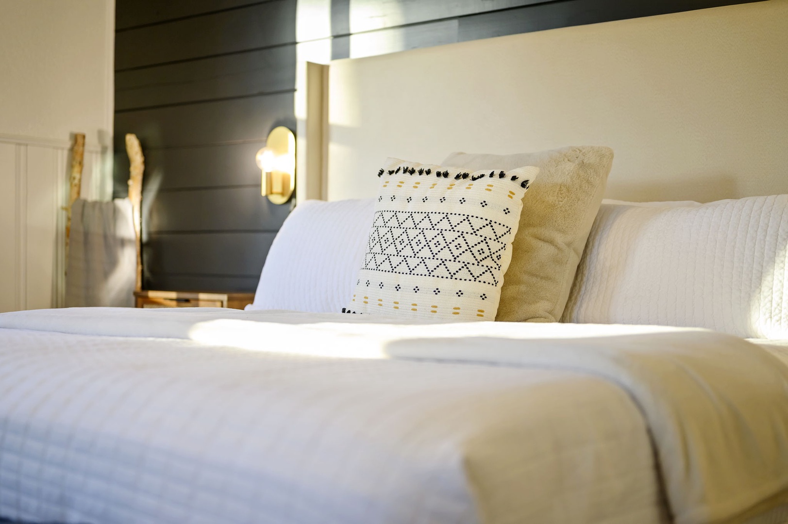 Sink into crisp white linens and plush pillows after your day of exploring. The warm bedside lighting creates the perfect ambiance for evening relaxation.