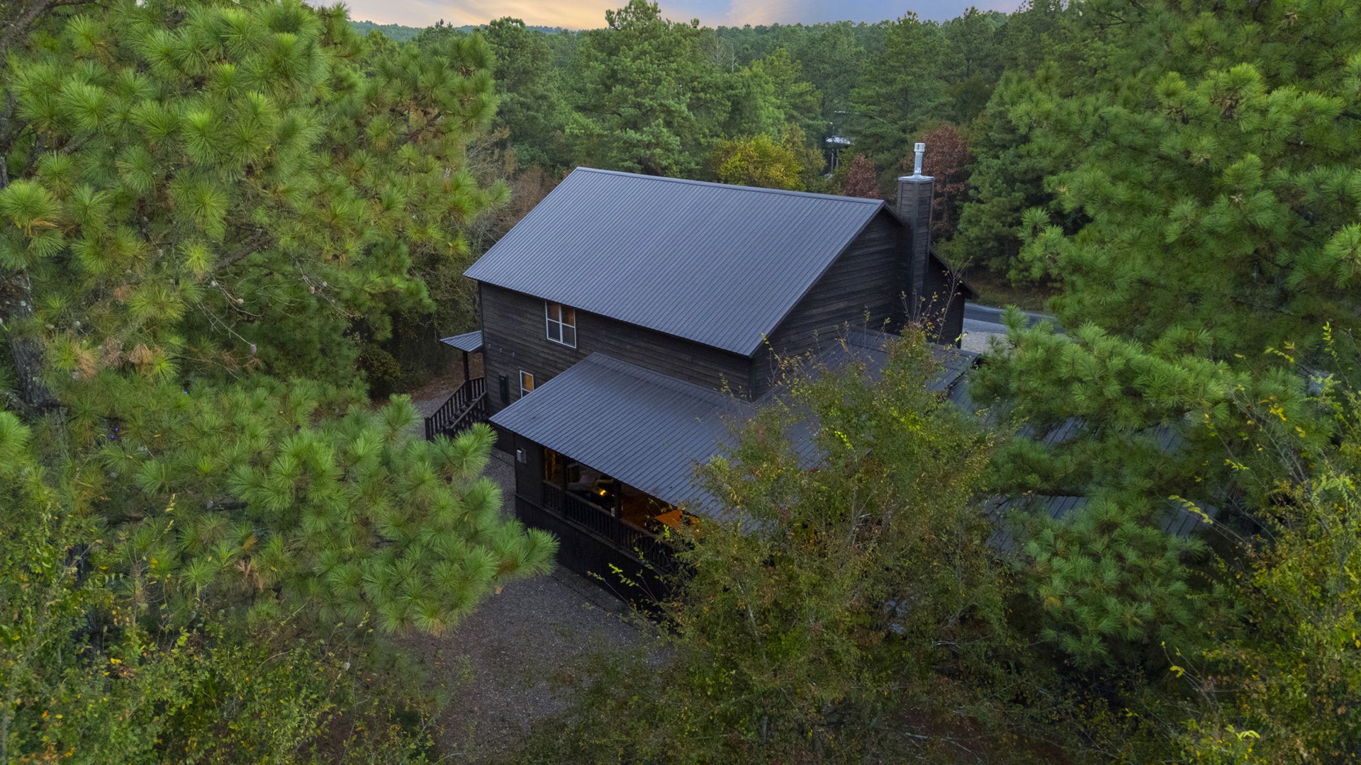 A secluded cabin retreat nestled privately among lush evergreen forests, offering a peaceful escape in a natural mountain setting with generous parking.