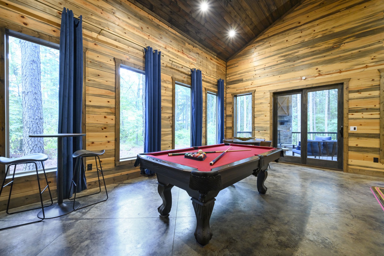 Challenge your travel companions to a friendly game at the full-size billiard table, set beneath soaring wood-paneled ceilings with forest views through every window.