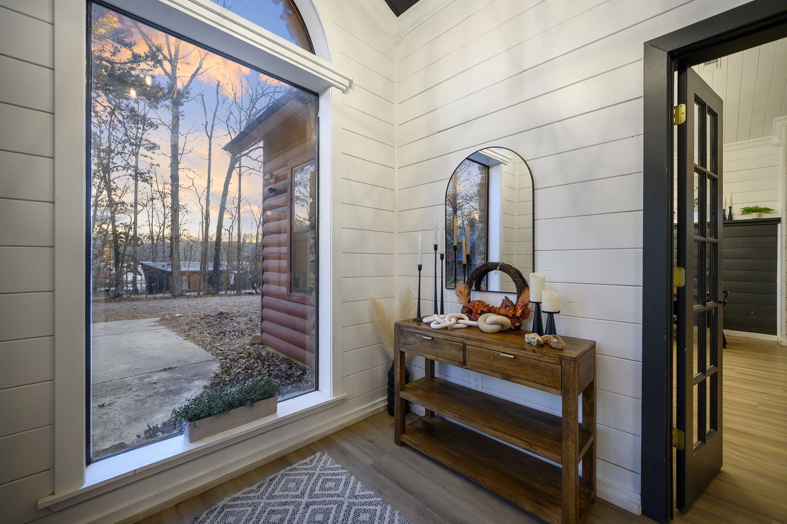 Step into your welcoming entryway with rustic charm, where shiplap walls and hardwood floors create warmth.