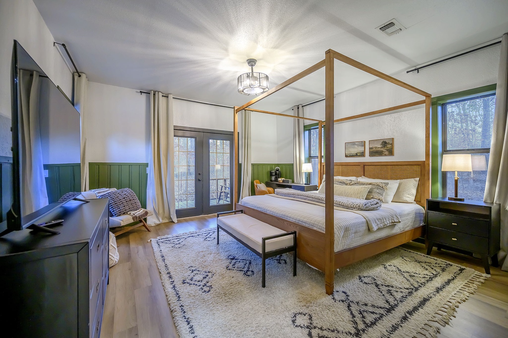 Retreat to your elegant four-poster bed sanctuary with stunning natural light streaming through floor-to-ceiling windows and modern amenities for ultimate comfort.