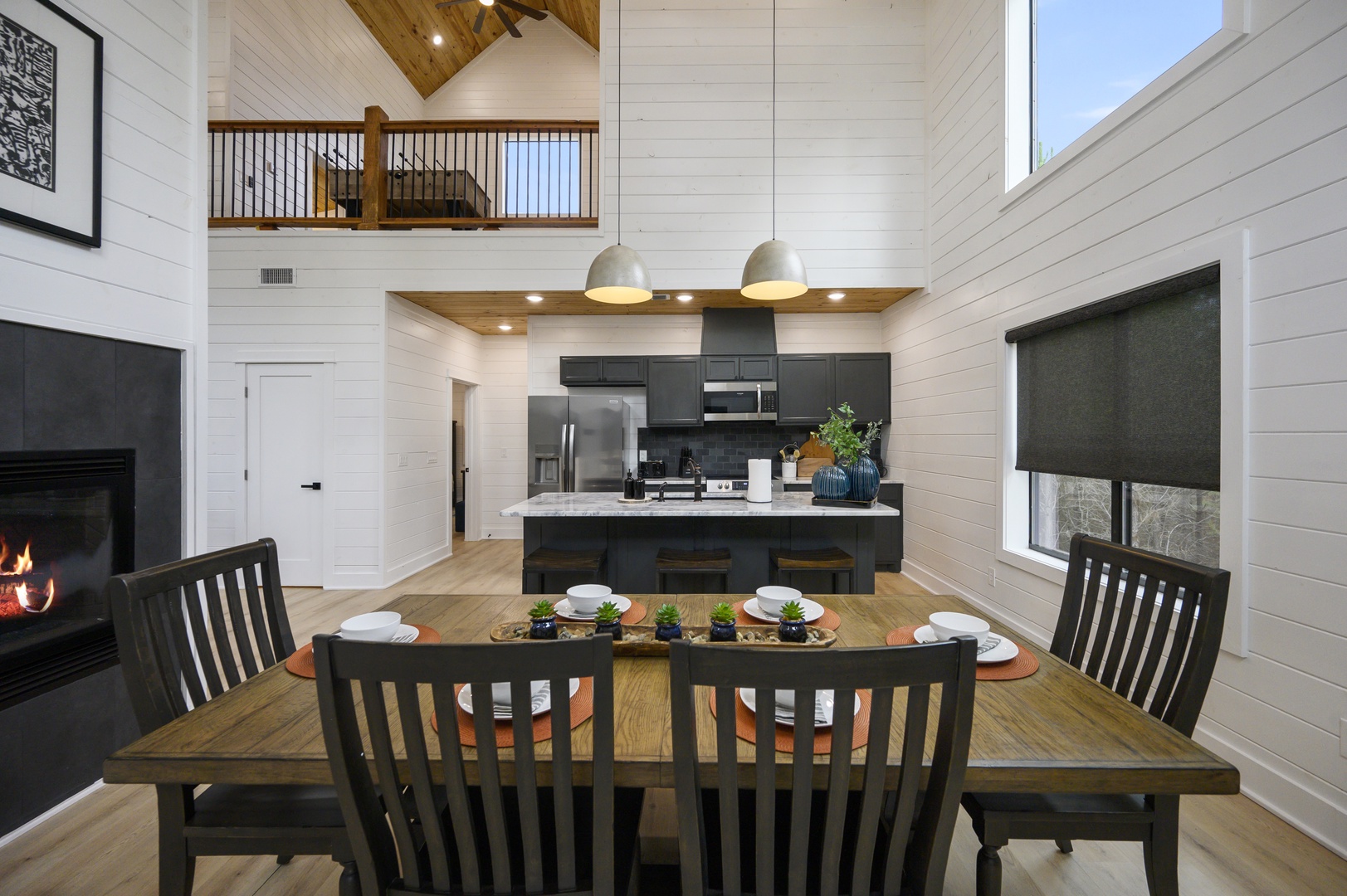Gather around your spacious dining table with stunning wood ceiling views and cozy fireplace creating the perfect atmosphere for memorable meals.