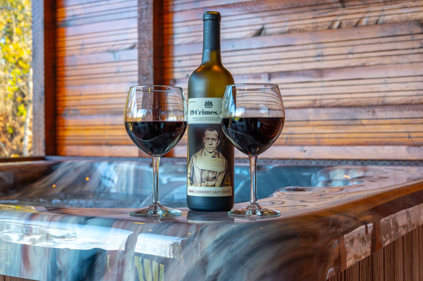 Unwind in your private hot tub with a glass of wine, surrounded by warm wood and natural light.