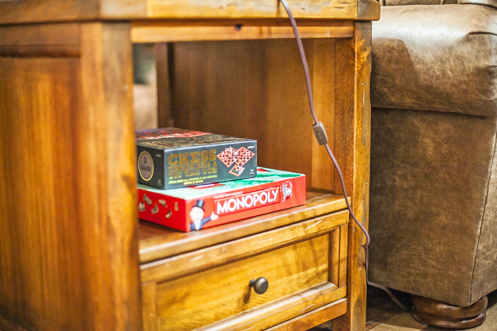 Cozy up for game night with classic board games waiting for you beside the comfortable seating area.