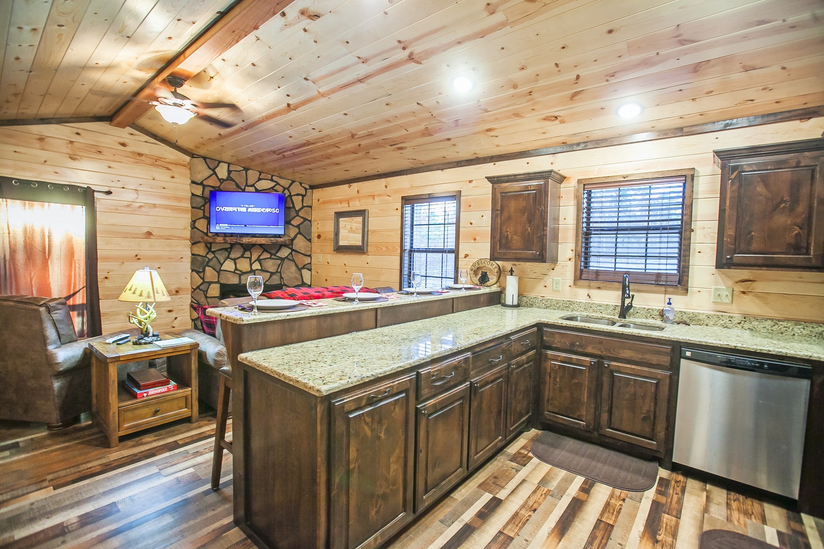 Your rustic cabin kitchen features granite countertops and modern appliances, perfect for preparing meals while enjoying mountain retreat vibes.