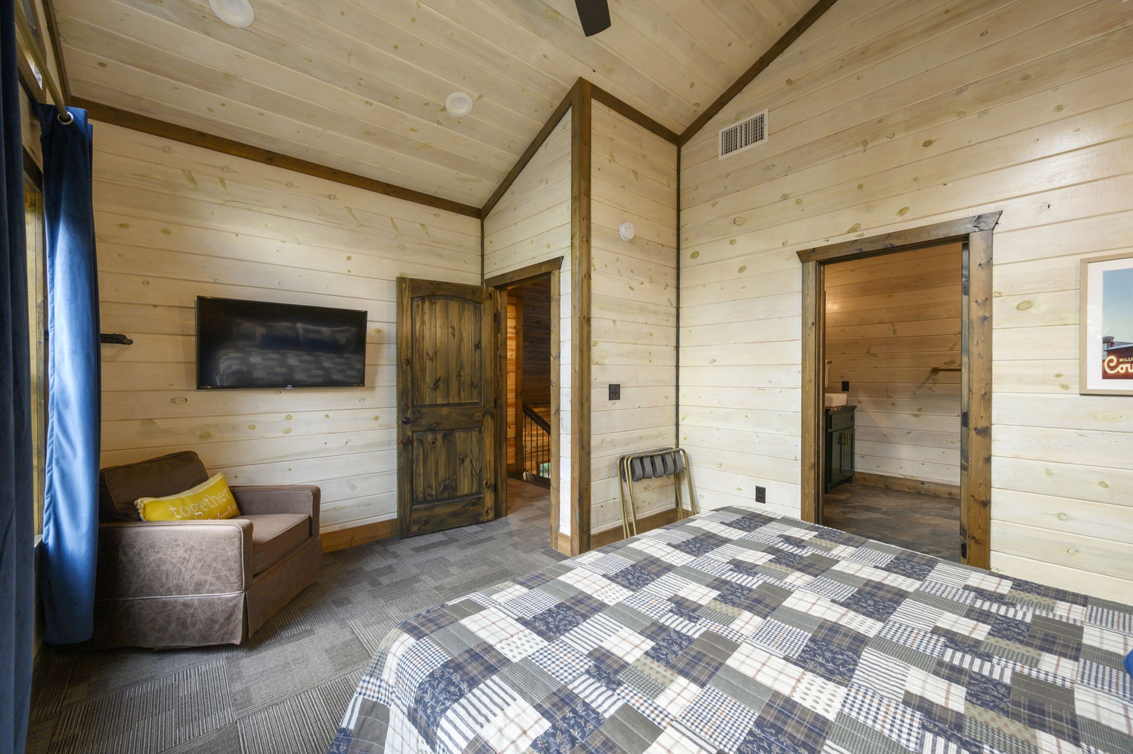Unwind in your cozy bedroom with vaulted wood ceilings and a private armchair for quiet moments. Your rustic retreat includes air conditioning for year-round comfort.