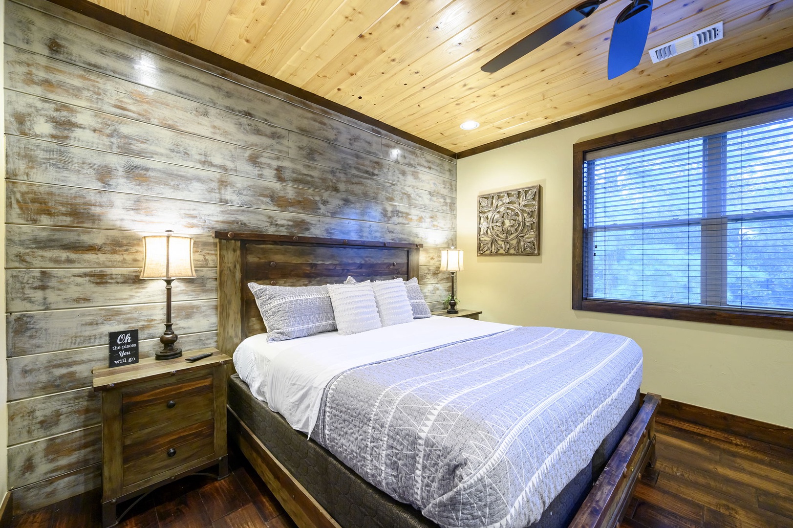 Slip into your private retreat featuring a plush king bed and rustic wood accent wall that adds warmth to every moment of your stay.