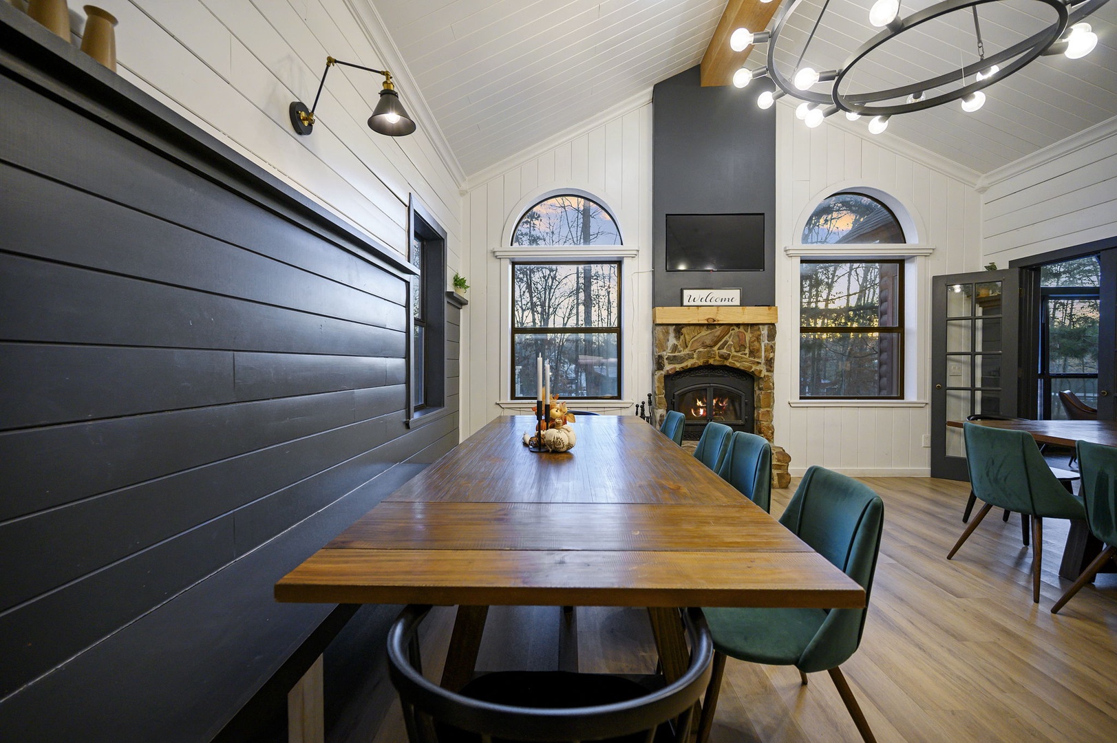 Gather around this stunning dining table with friends, where warm firelight creates perfect moments for unforgettable meals and conversations.