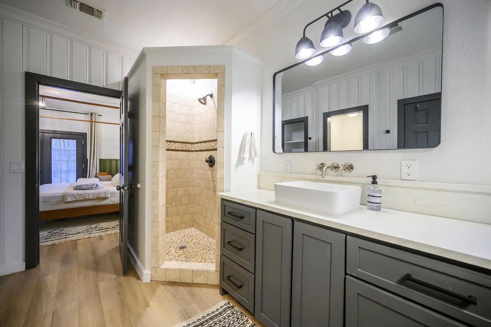 Your spacious bathroom features beautiful tile work and modern finishes, with a luxurious walk-in shower just steps from your cozy bedroom.