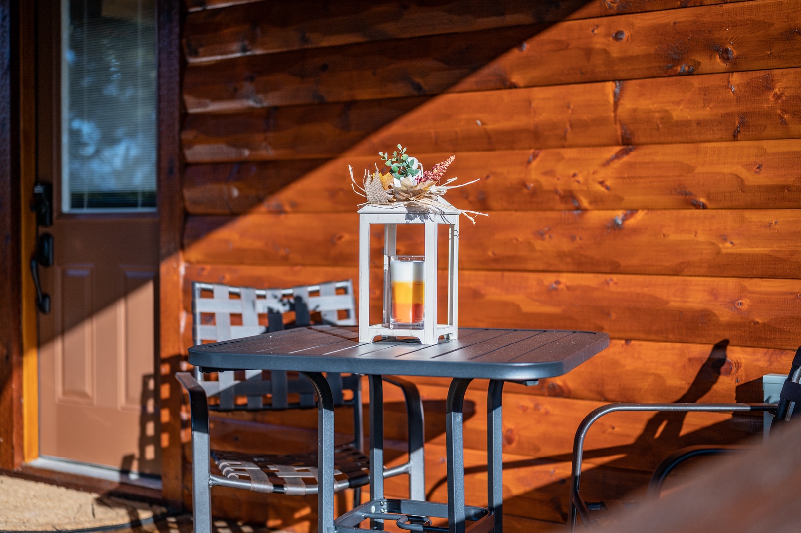 Unwind on your private balcony with warm wood surroundings and a cozy table setting perfect for morning coffee or evening relaxation.