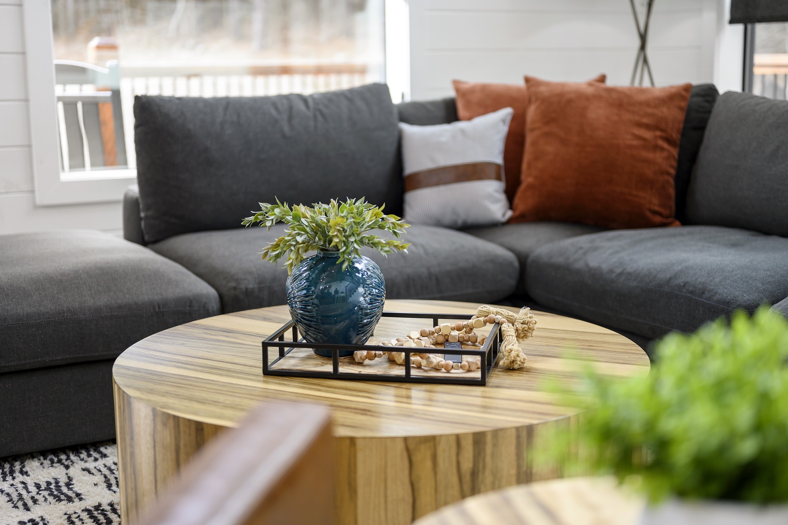 Sink into the plush sectional sofa where thoughtful touches and natural light create your perfect retreat for relaxation.