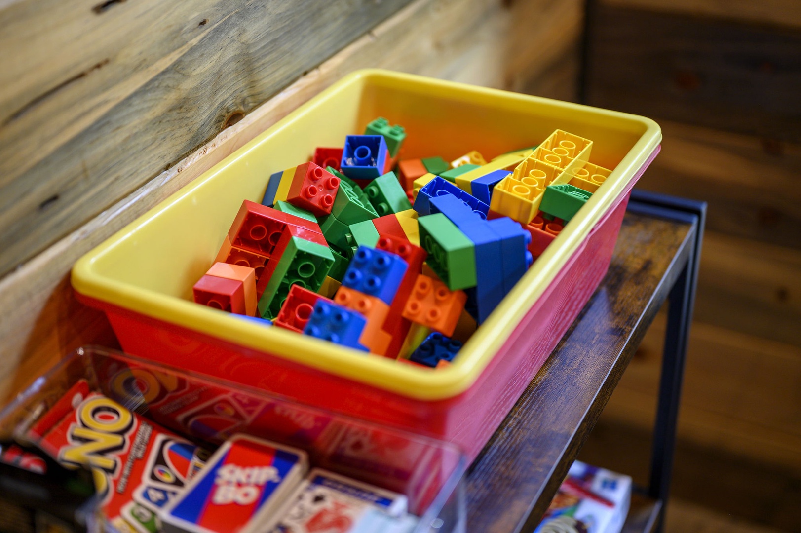 Colorful building blocks await your little ones' imagination on rustic wooden surfaces, ready for hours of creative play.