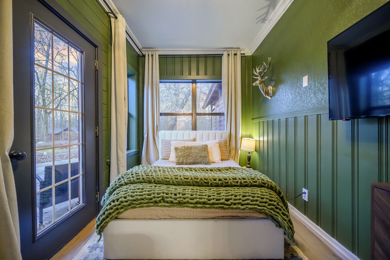 Drift into peaceful dreams in your cozy forest retreat, wrapped in soft textures with nature just outside your door.