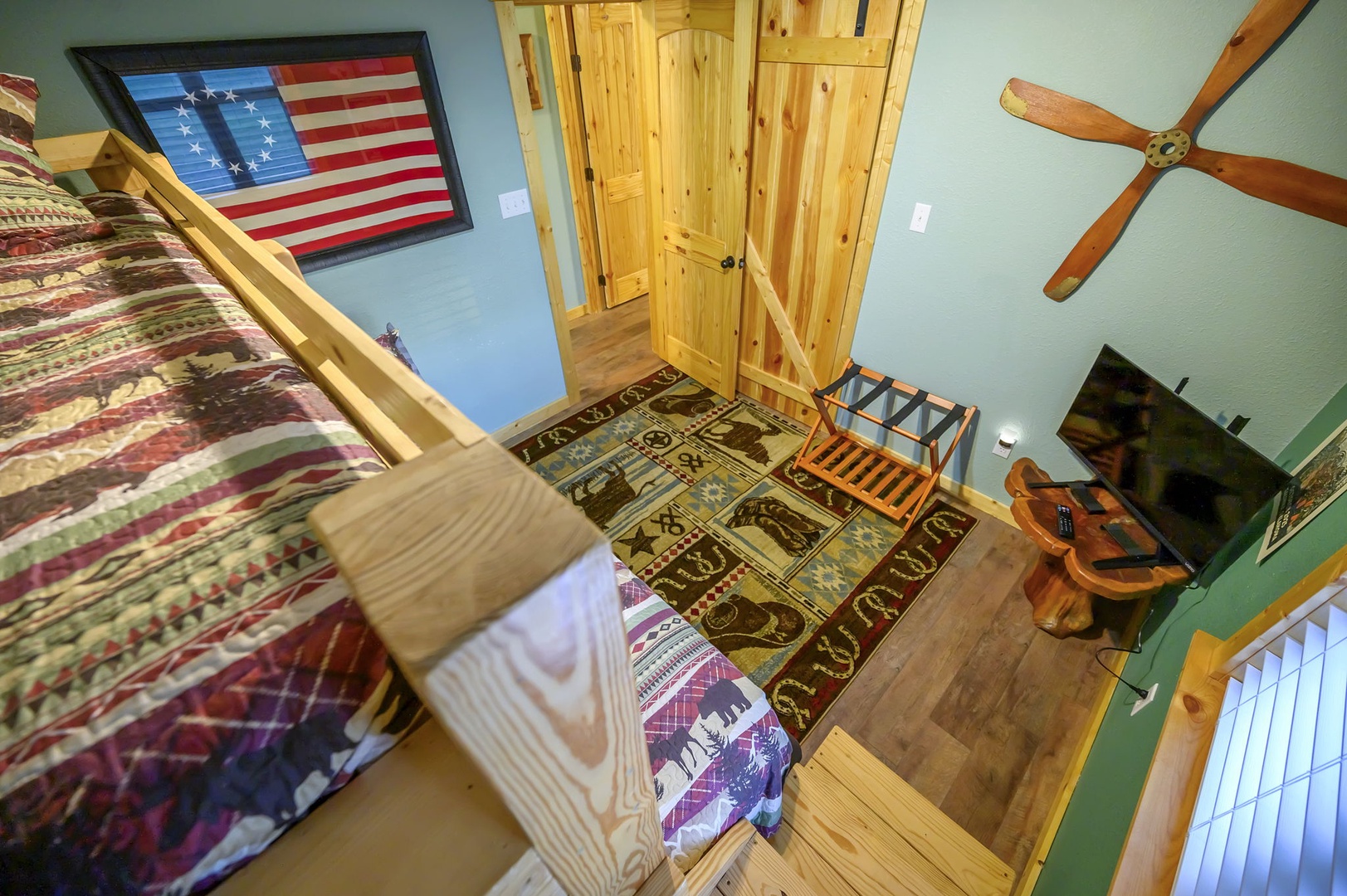 Your rustic bedroom features cozy log bunk beds, warm wood details, and charming cabin décor for the perfect mountain retreat experience.