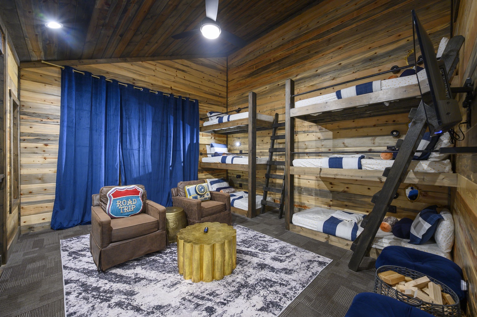 Your private bunk room awaits, where rustic wood beams meet cozy seating and plenty of space for the whole crew to unwind after a day of adventure.