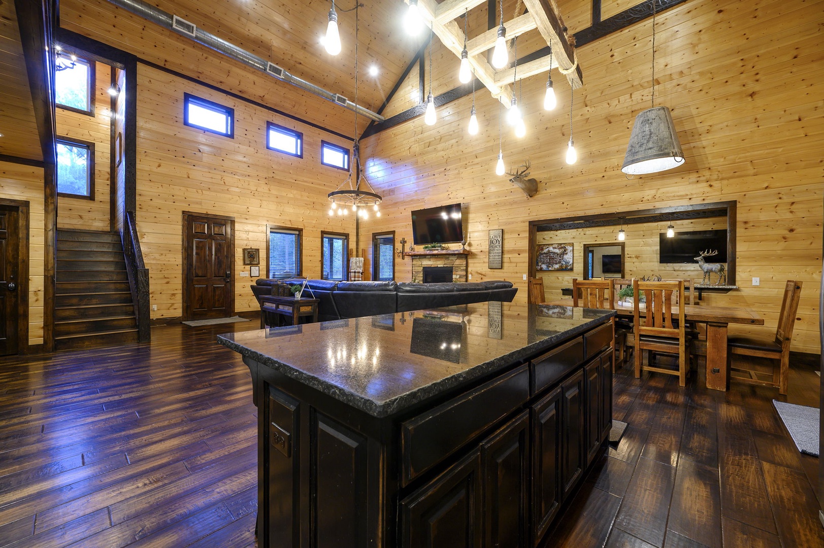 Mountain escape with soaring cathedral ceilings, warm pine walls, and rich hardwood floors. Open great room flows from gourmet kitchen to cozy living area—perfect for gathering with loved ones.
