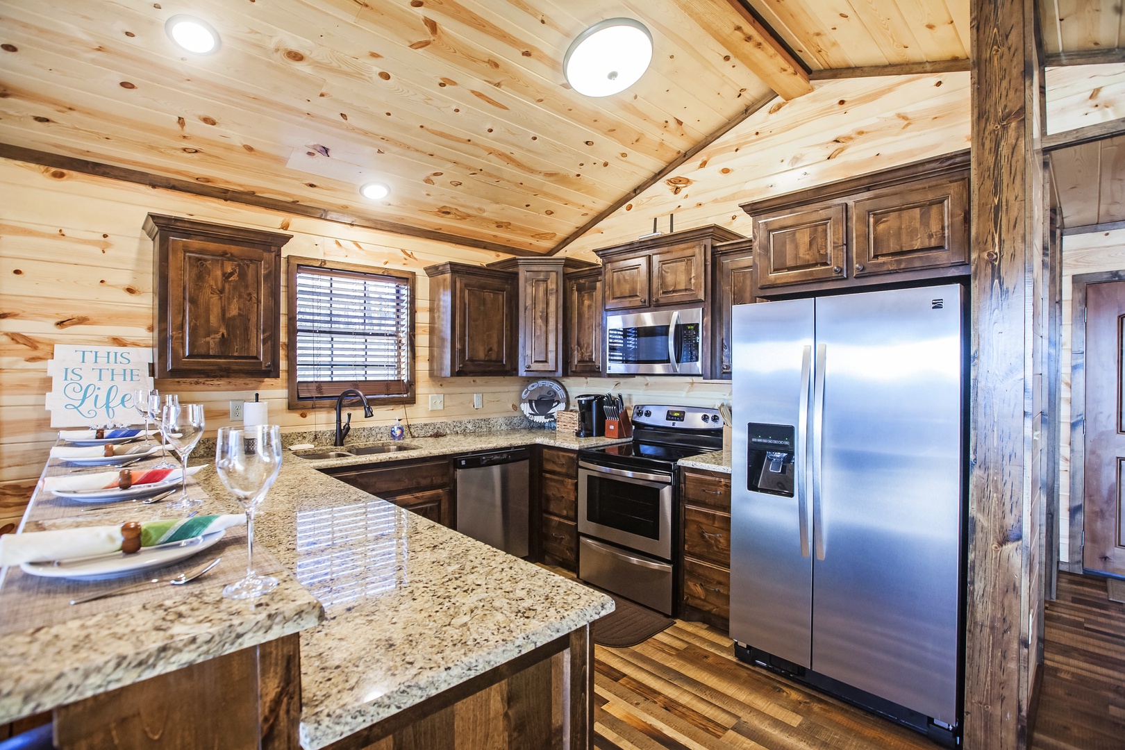 Your rustic kitchen combines warm wood beams with modern stainless appliances and granite counters for memorable meal prep.