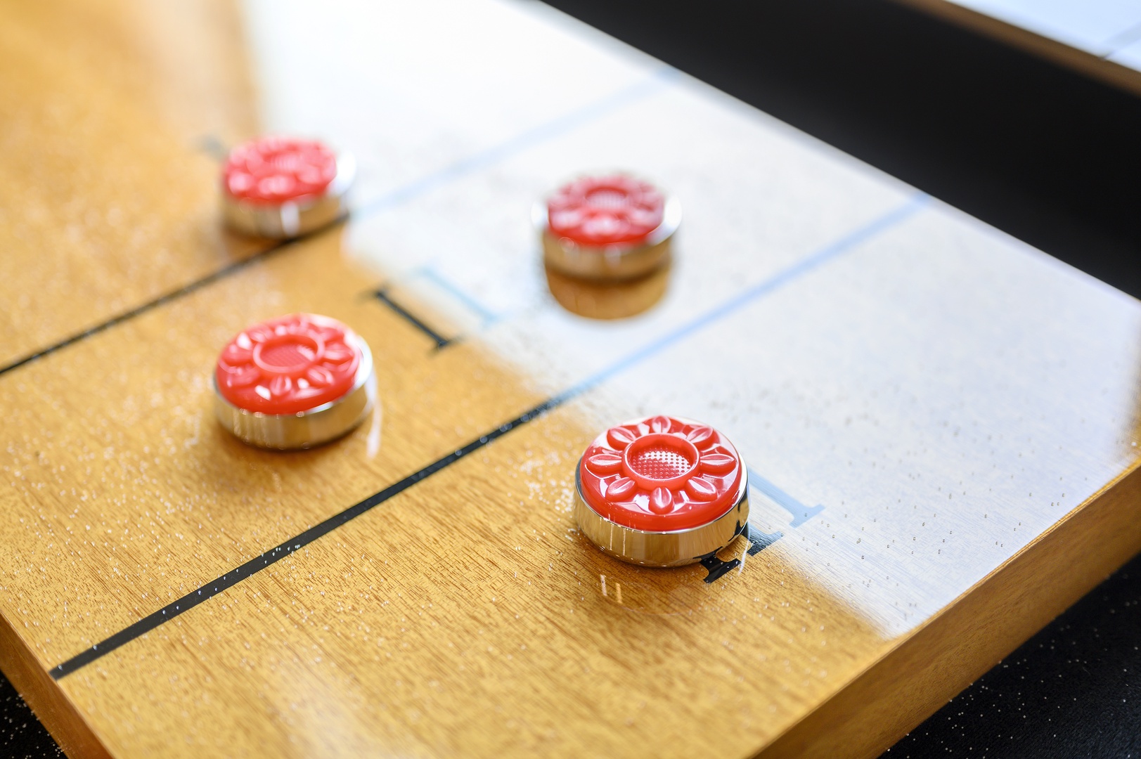 Challenge friends to a classic game of shuffleboard in your game room, where memorable evenings unfold.
