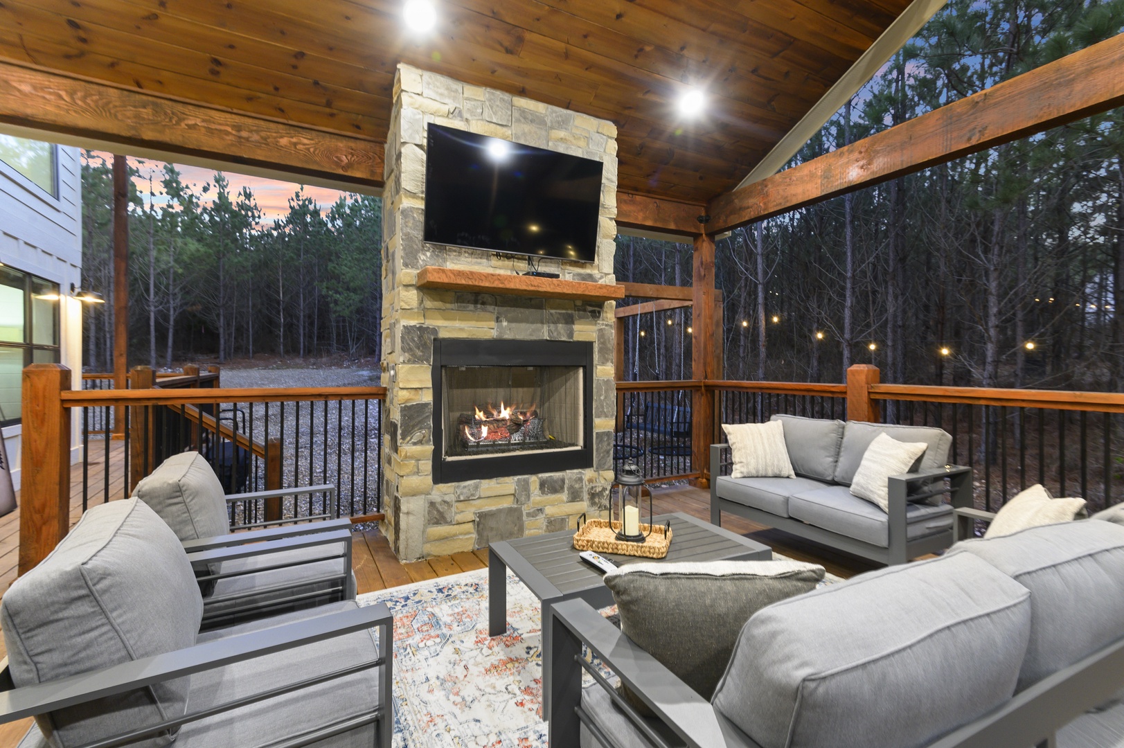 Gather around the crackling fireplace on your private covered deck, where cozy seating and warm lighting create perfect evenings under the stars.