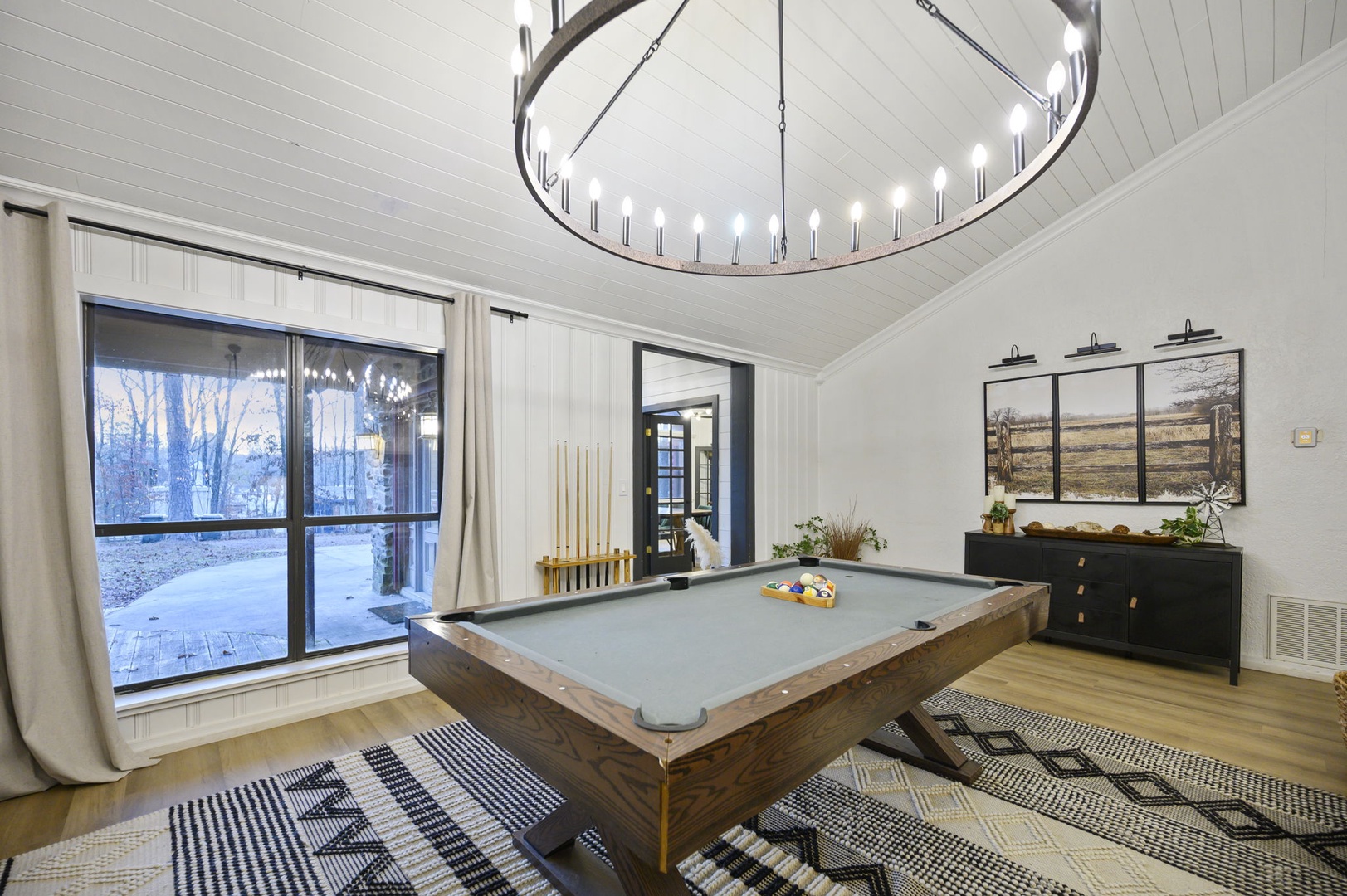 Step into your private game room featuring a regulation pool table beneath a stunning circular chandelier, where winter evenings become memorable.