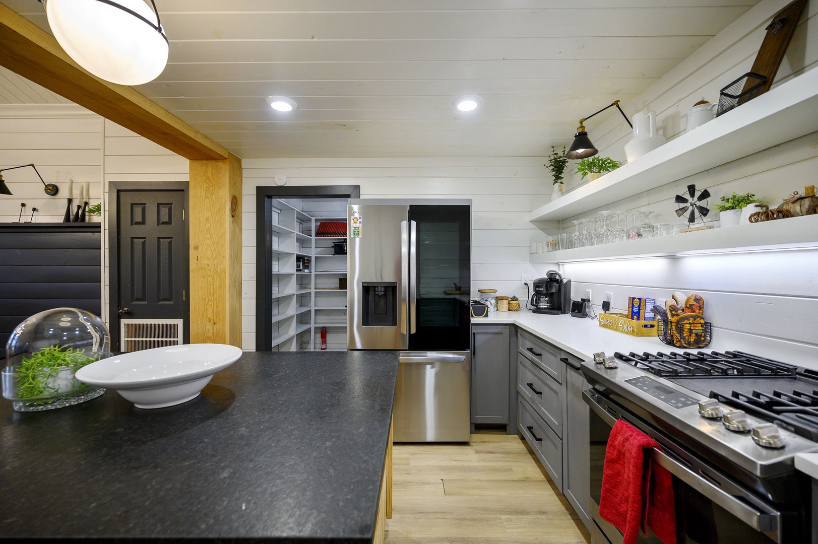 Your spacious kitchen features granite counters, gas stove, and open pantry for culinary adventures.