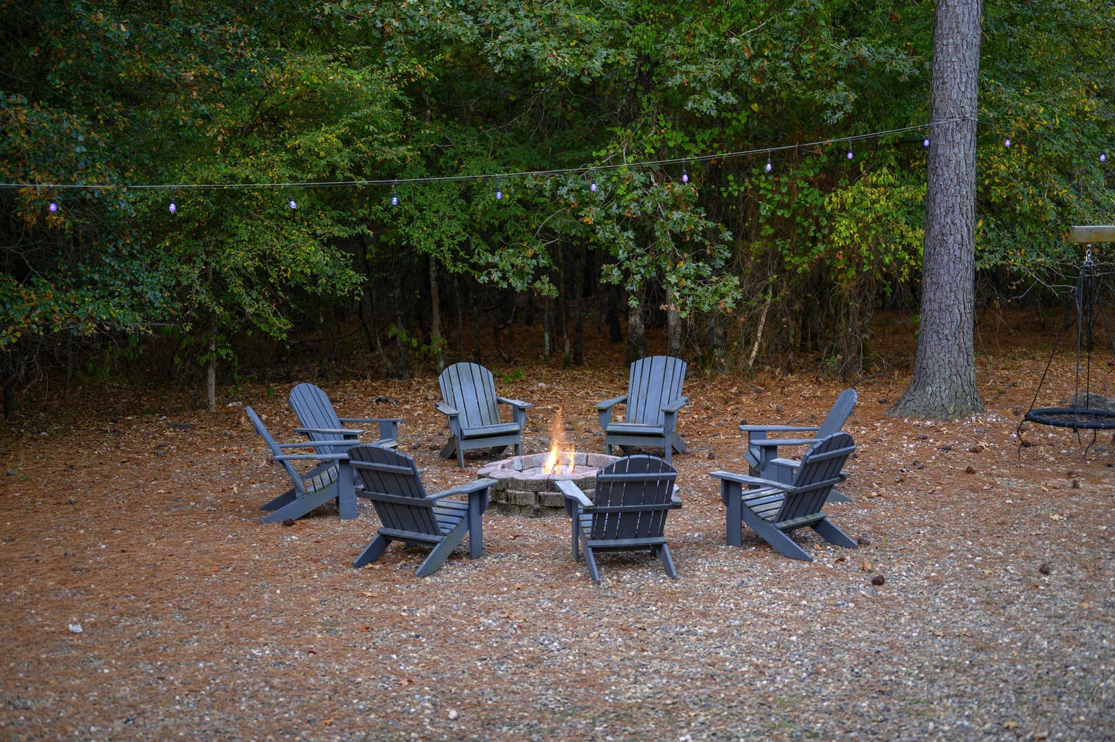 Gather around the fire pit as evening falls, where string lights overhead and Adirondack chairs create your perfect retreat for starlit conversations and s'mores.