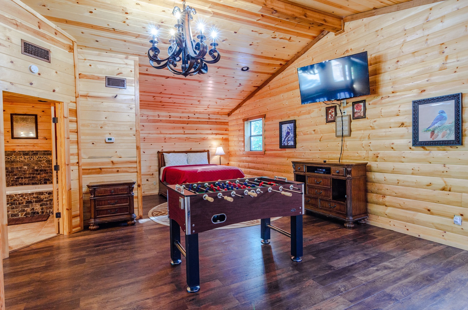 Your private game room awaits with a foosball table, flat-screen TV, and charming rustic wood décor—perfect for spirited competition and laughter after a day exploring the area.