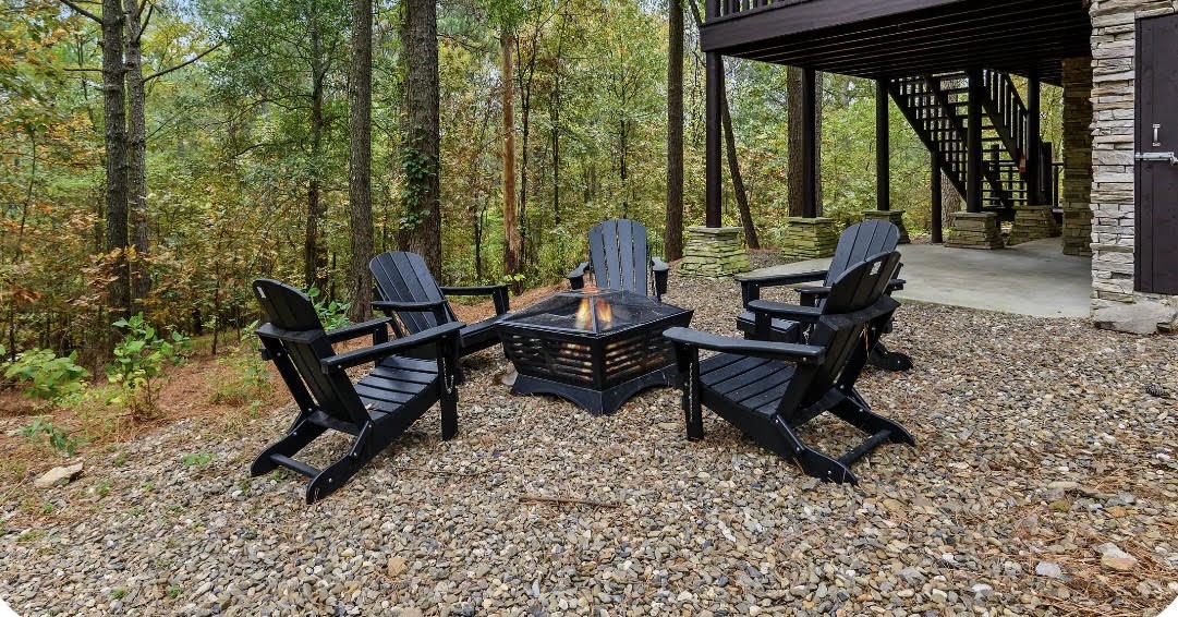 Gather around the fire pit in these cozy Adirondack chairs, surrounded by peaceful forest views—a perfect spot to unwind after exploring the area.