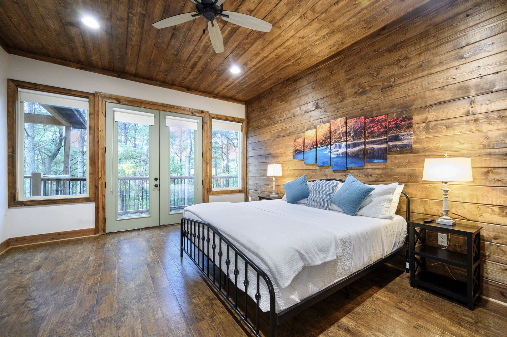 Sink into crisp linens and wake to forest views through your private balcony doors. The warm wood walls and soft lighting create a peaceful retreat after your day exploring.