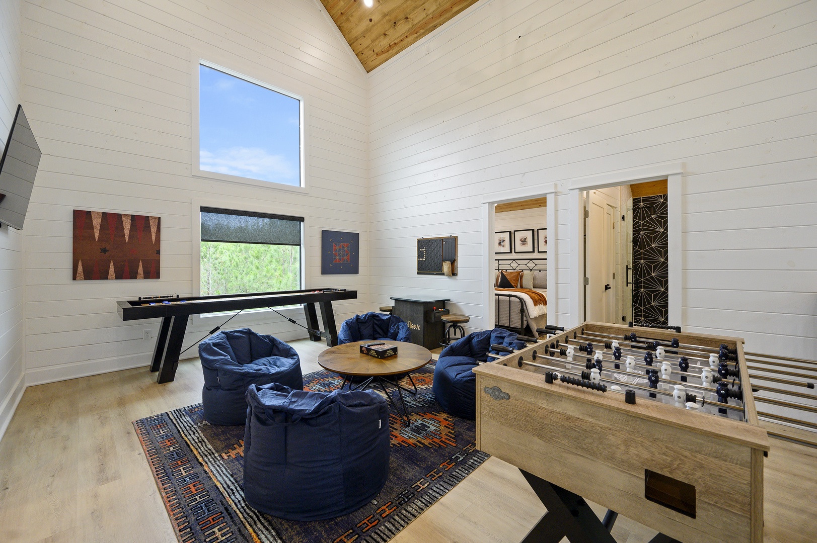 Unwind in your game room with foosball, pool table, and cozy bean bag seating for endless entertainment.