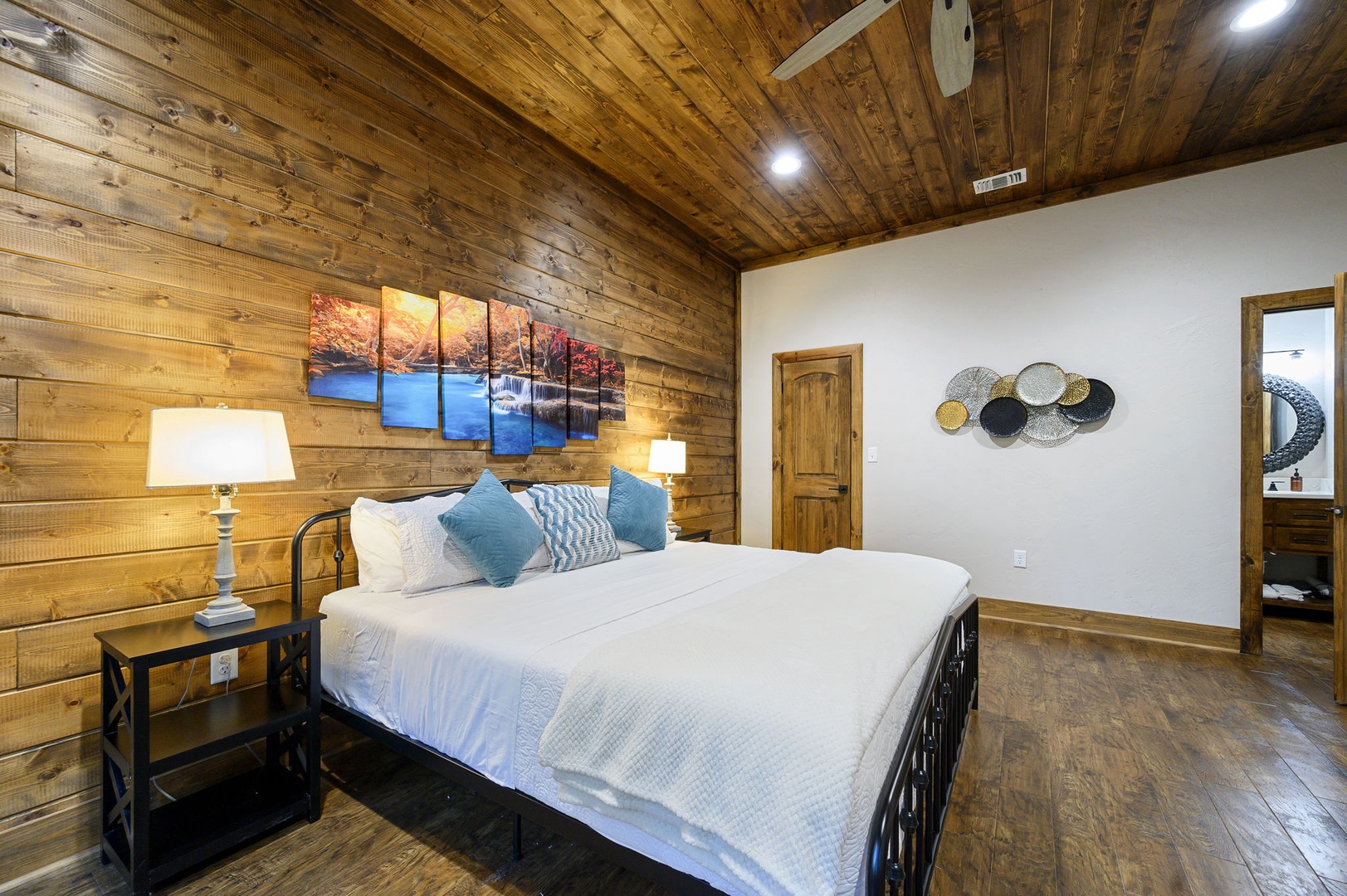 Drift into restful sleep in your inviting bedroom, wrapped in rustic wood warmth and crisp white linens. Soft lighting and thoughtful touches create a peaceful retreat after your day of adventure.