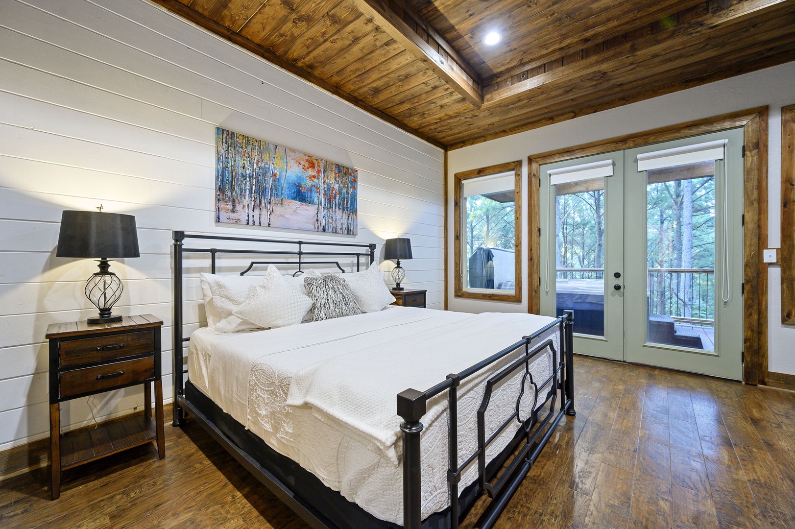 Wake up to natural light streaming through your private balcony doors, where forest views welcome each new day in your rustic-elegant retreat.