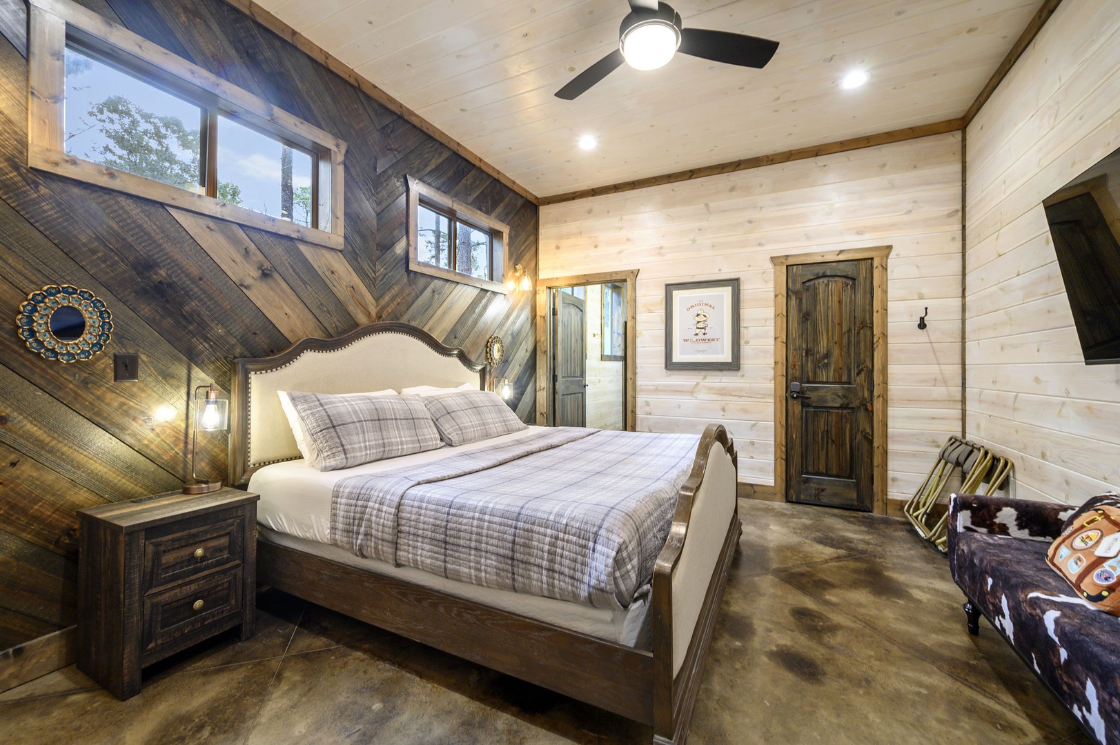 Drift off under soaring ceilings and rustic wood accents that wrap you in warmth. Soft plaid bedding and charming décor set the tone for your restful mountain retreat.