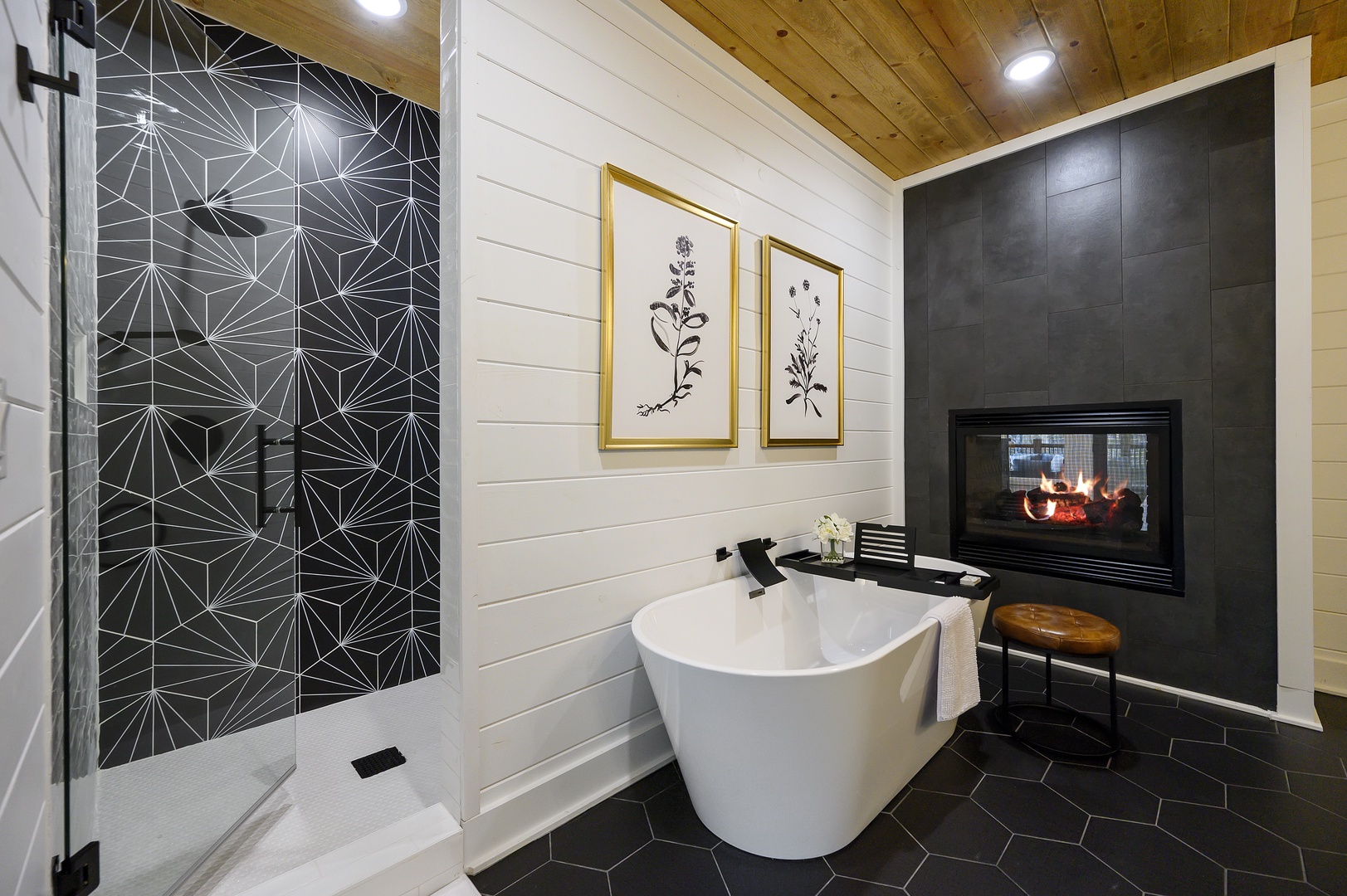 Unwind in your private spa retreat with a soaking tub, fireplace, and stunning geometric shower for ultimate relaxation.