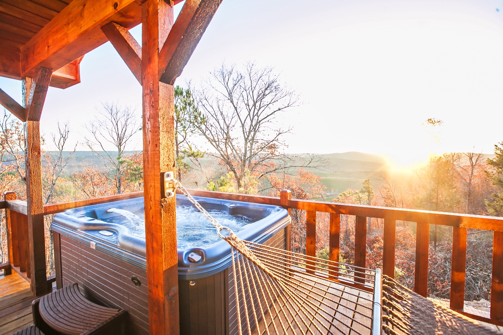 Unwind in your private hot tub while autumn colors frame mountain vistas, then sway in the hammock as golden sunlight bathes your peaceful retreat.