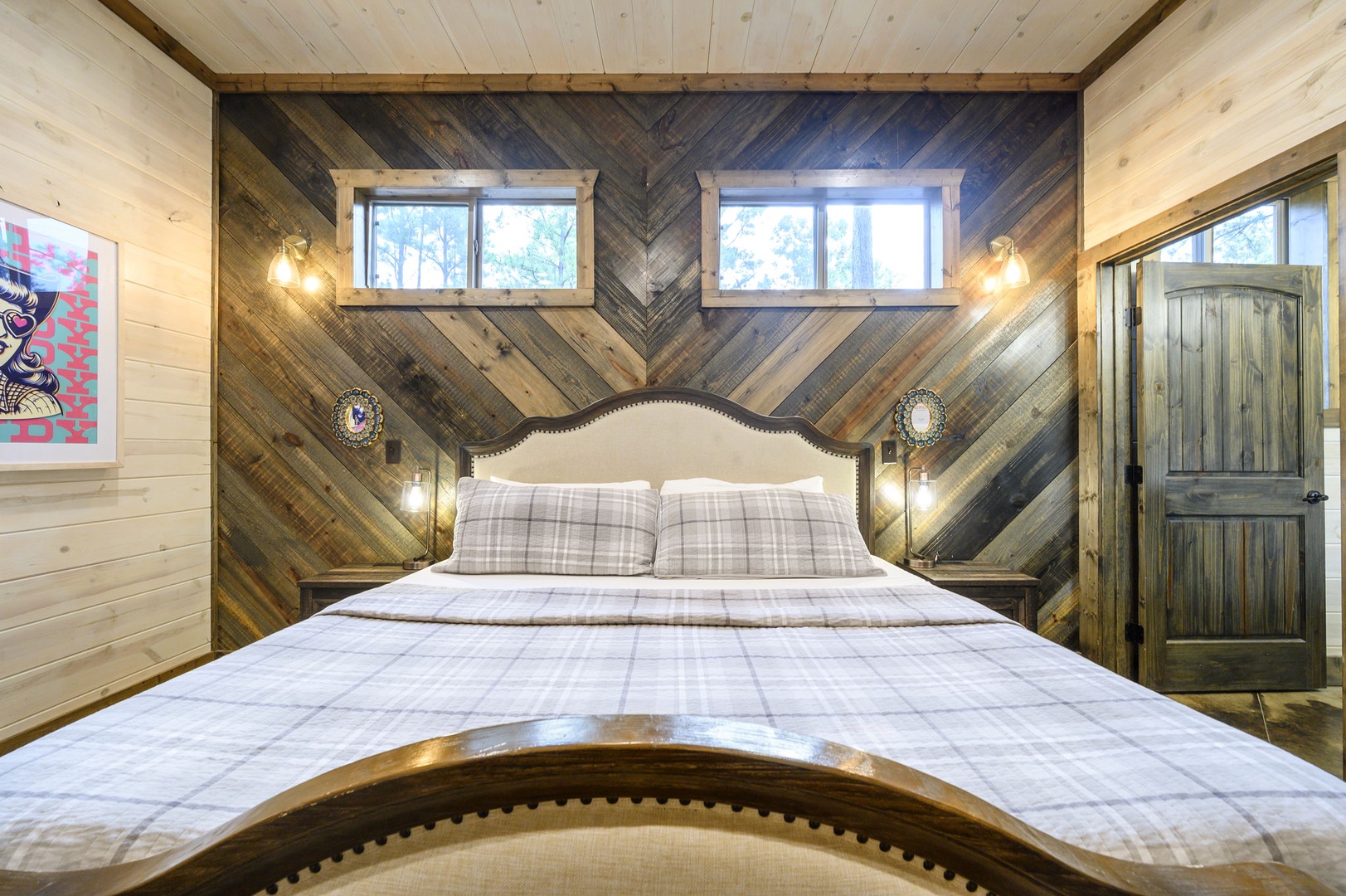 Sink into your plush bed beneath warm wooden beams and cozy plaid linens, where rustic charm meets modern comfort in this thoughtfully crafted retreat.