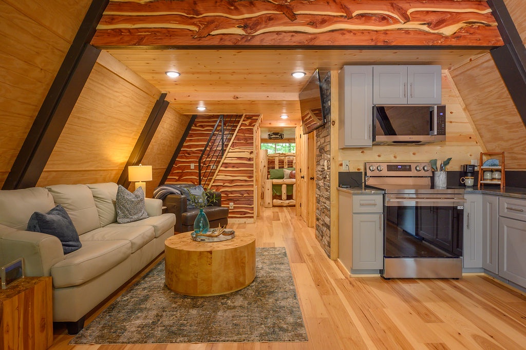 Unwind in your cozy A-frame retreat with soaring cedar beams, a fully equipped kitchen, and warm wood accents that wrap you in rustic charm.