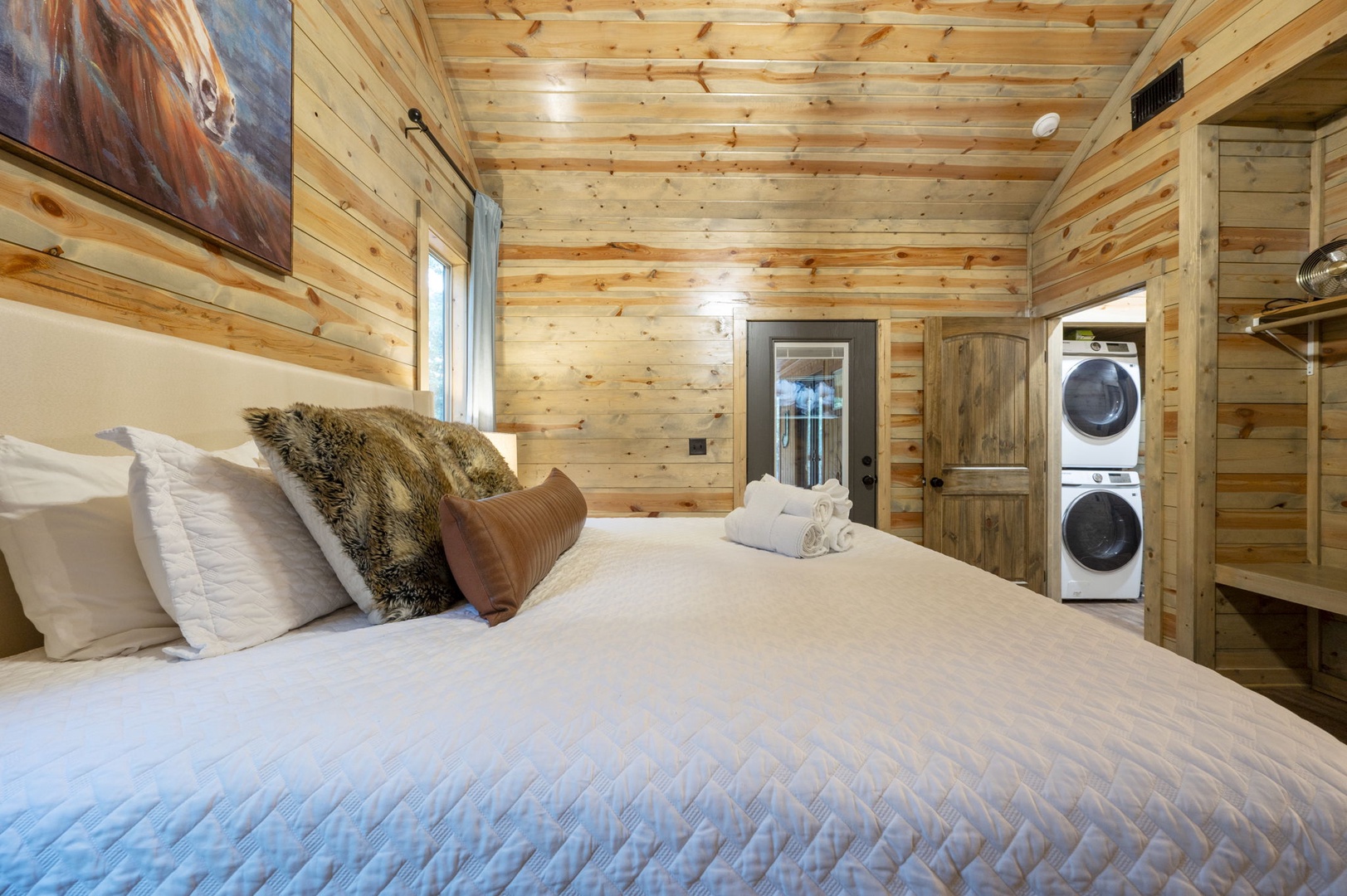 Sink into plush comfort surrounded by warm, natural wood that wraps you in cozy cabin charm, with fresh towels and convenient in-room laundry making your stay effortlessly relaxing.