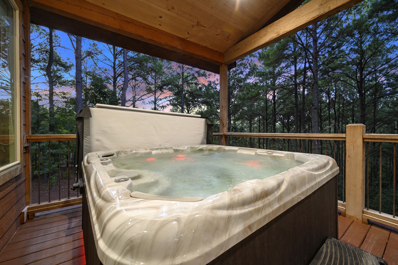 Soak in your private hot tub under a canopy of towering pines as the sky blushes pink and purple at dusk—pure mountain serenity awaits.