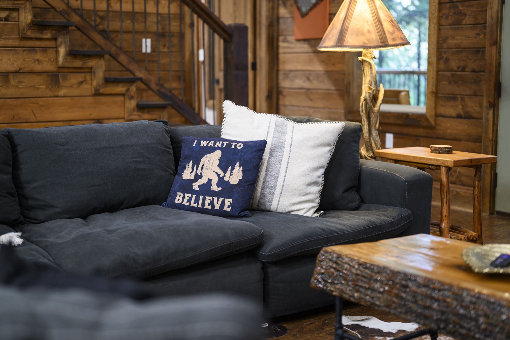 Sink into plush cushions and feel the warmth of rustic wood surround you, with a playful nod to mountain mysteries adding charm to your retreat.