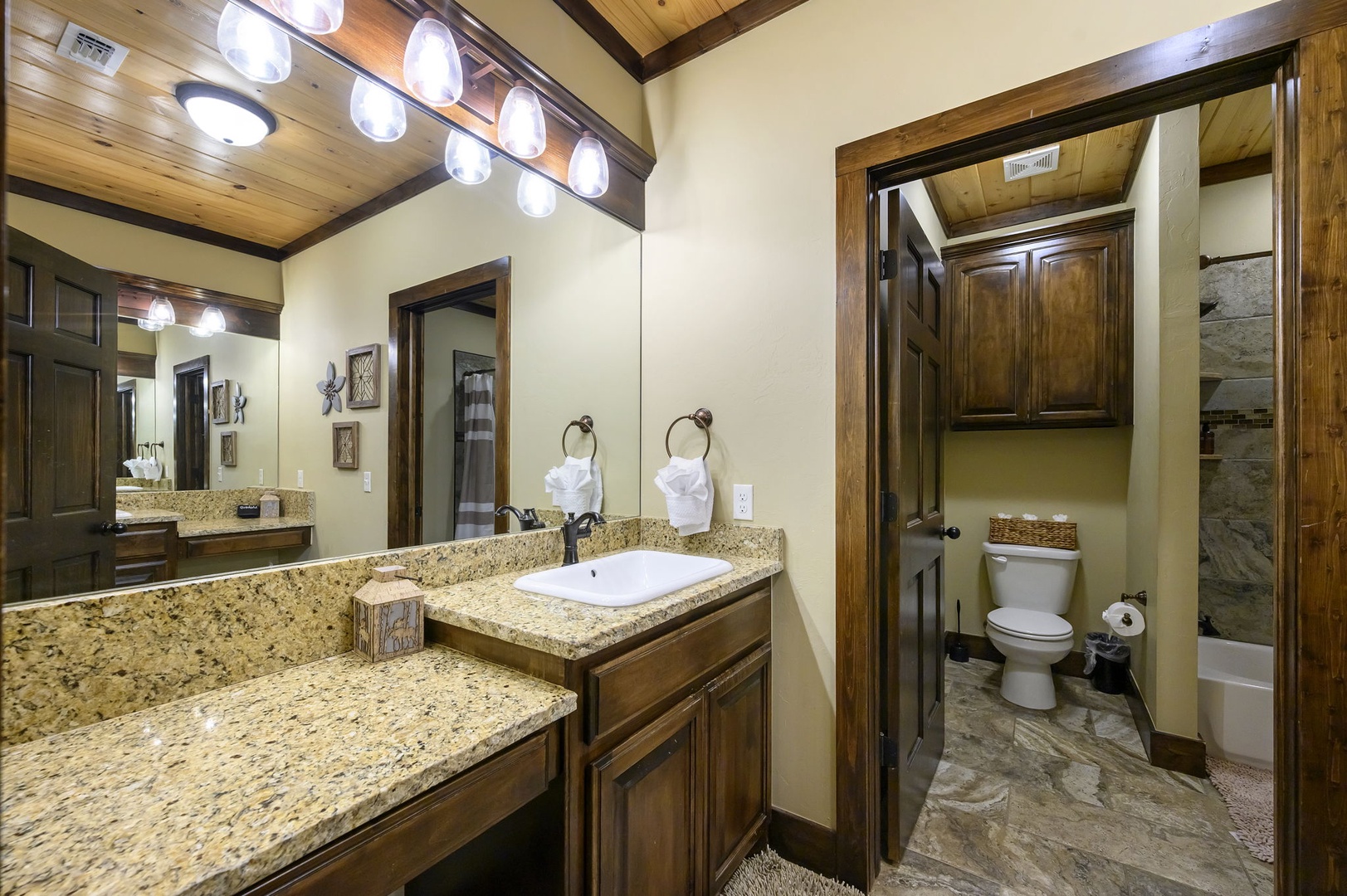 Step into your private retreat with gleaming granite counters, warm wood finishes, and spa-like lighting overhead. The spacious dual vanity invites you to unwind, while crisp towels and thoughtful details make every moment feel like a getaway.