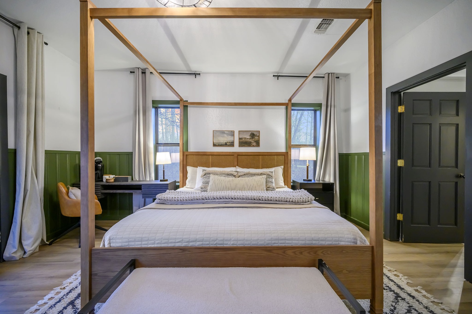 Your elegant four-poster bed awaits in this stylish sanctuary, where warm wood tones and crisp linens create the perfect retreat after exploring.