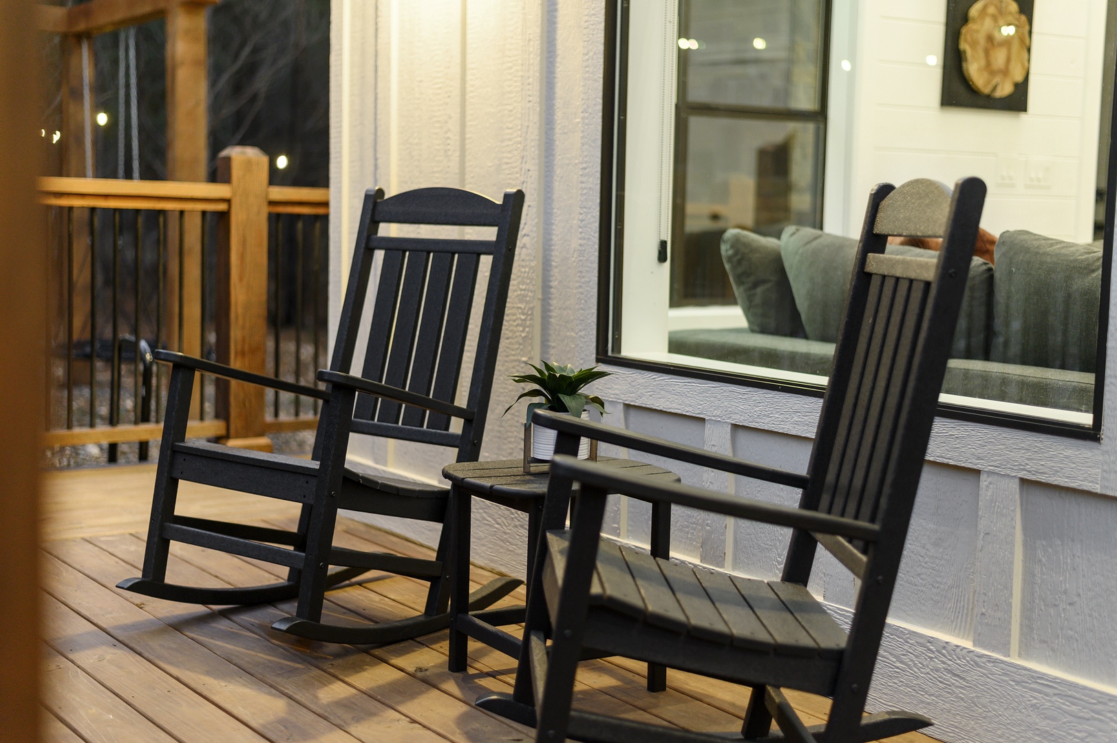 Unwind on your private deck with charming rocking chairs, where gentle evening breezes and twinkling lights create the perfect spot for peaceful moments.