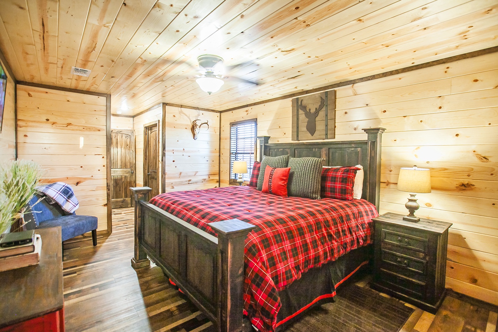 Cozy up in your rustic cabin bedroom with warm wood walls, plaid bedding, and charming decor that whisks you away to the perfect mountain retreat.