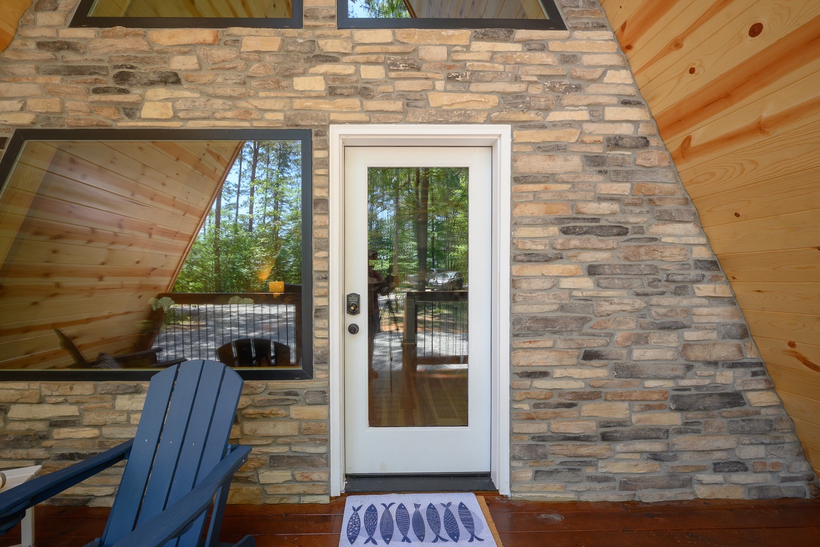 Your private entryway welcomes you with rustic stone and warm wood accents, opening to a peaceful wooded retreat where relaxation awaits.
