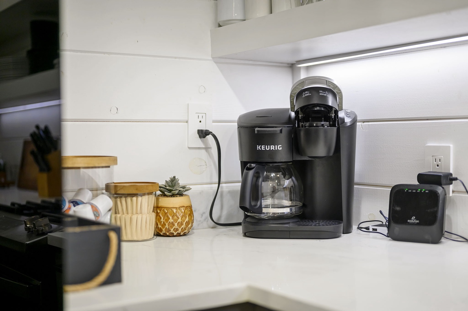 Start your mornings right with this sleek Keurig coffee maker, perfectly positioned in your stylish kitchen for convenient brewing.