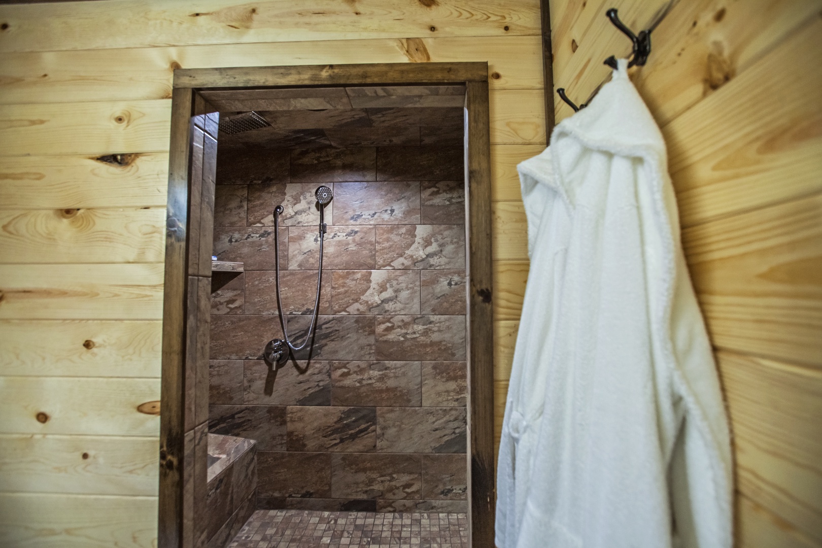 Step into your private stone shower sanctuary, where warm wood and natural materials create a spa-like retreat for refreshing moments.